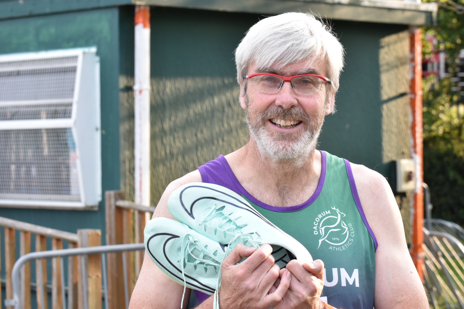 runner holding shoes